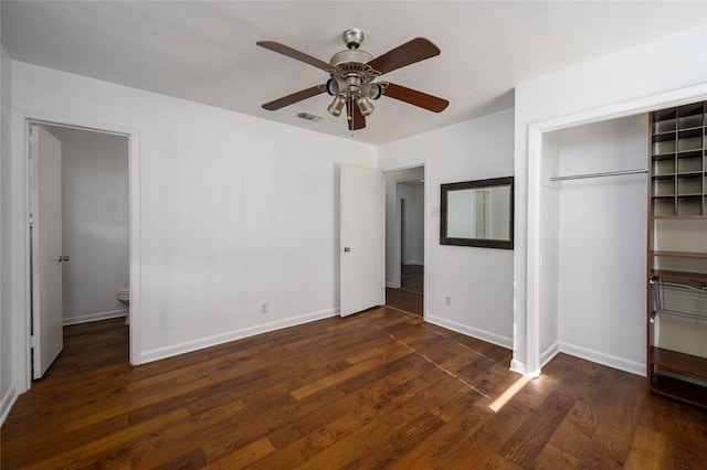 unfurnished bedroom featuring dark hardwood / wood-style flooring, a closet, ceiling fan, and connected bathroom