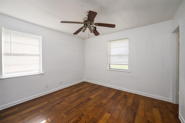 empty room with dark hardwood / wood-style floors and ceiling fan