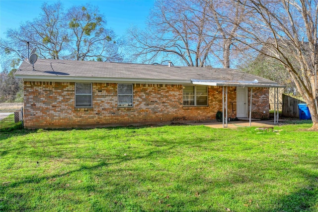 back of property featuring a lawn and a patio