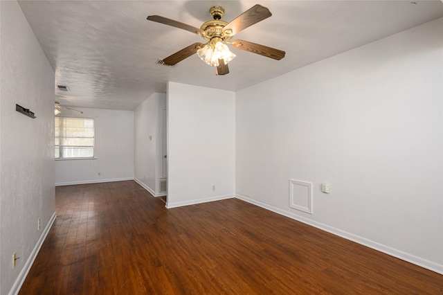 spare room featuring ceiling fan and dark wood-type flooring