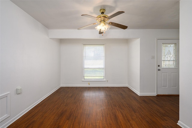 empty room with ceiling fan and dark hardwood / wood-style floors