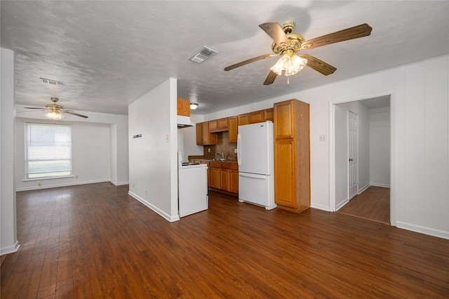 kitchen featuring dark hardwood / wood-style flooring, white appliances, a textured ceiling, ceiling fan, and sink