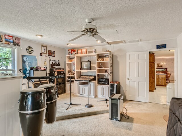 carpeted office space featuring a textured ceiling and ceiling fan