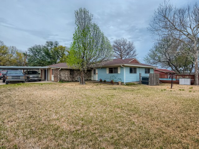 exterior space featuring a front yard and a carport