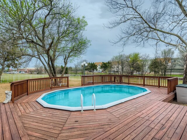 view of swimming pool with a deck