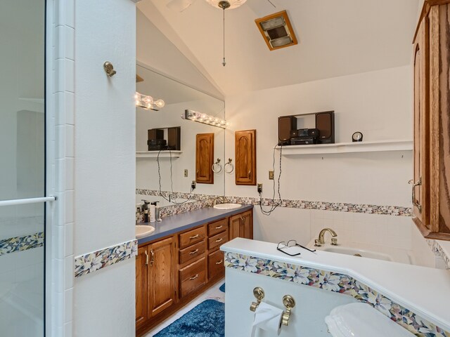 bathroom featuring vanity, plus walk in shower, and vaulted ceiling