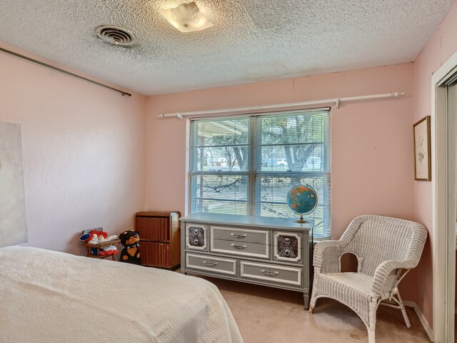 carpeted bedroom with a textured ceiling