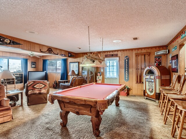 recreation room with carpet, plenty of natural light, wood walls, and billiards