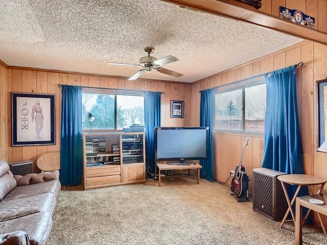 living room featuring carpet flooring, ceiling fan, and wooden walls