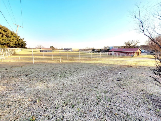 view of yard with a rural view and an outdoor structure