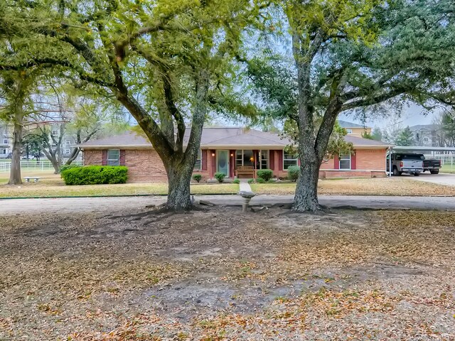 single story home with covered porch and a carport