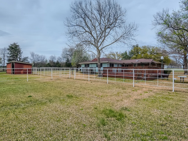 view of yard with a rural view and an outdoor structure