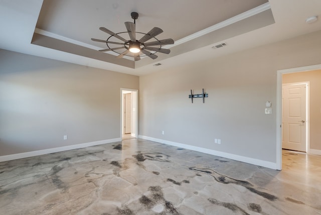 unfurnished room with a tray ceiling, ceiling fan, and crown molding