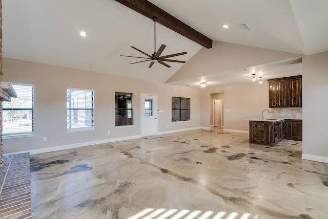 unfurnished living room featuring ceiling fan, beam ceiling, sink, and high vaulted ceiling