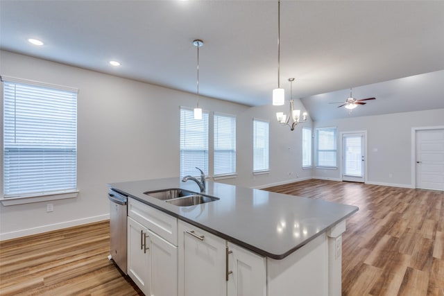 kitchen featuring sink, an island with sink, white cabinets, decorative light fixtures, and stainless steel dishwasher