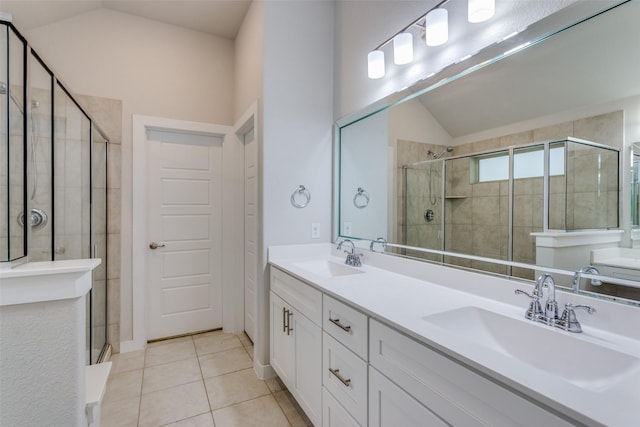 bathroom with lofted ceiling, vanity, tile patterned flooring, and walk in shower