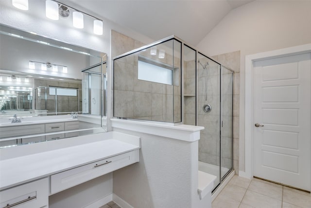 bathroom with a shower with door, vanity, vaulted ceiling, and tile patterned flooring