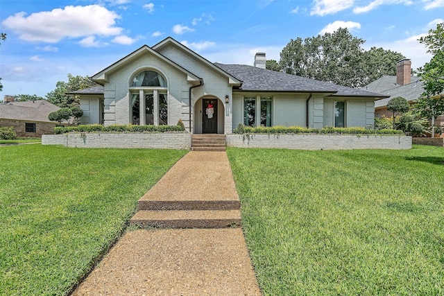 ranch-style home featuring a front yard