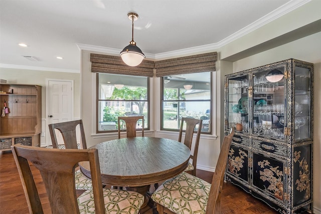 dining area with ornamental molding and dark hardwood / wood-style floors