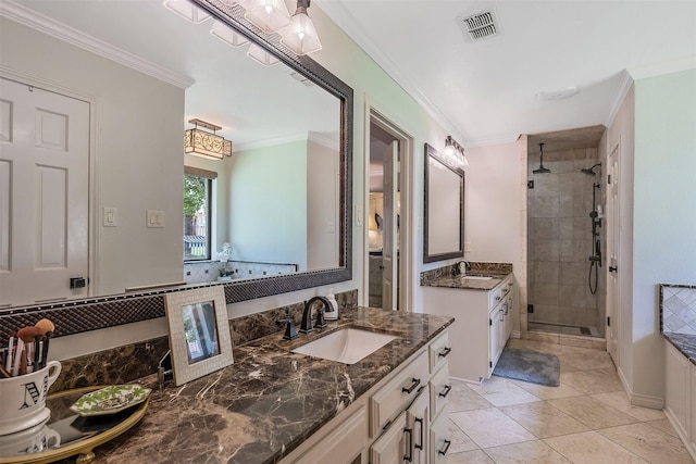 bathroom featuring a shower with door, crown molding, vanity, and tile patterned floors