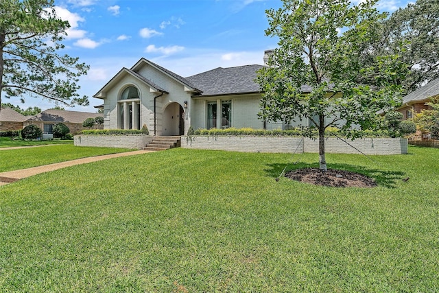 ranch-style home with a front lawn