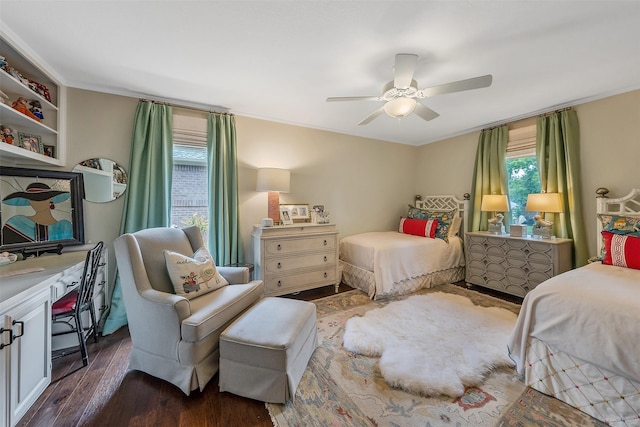 bedroom featuring ceiling fan, ornamental molding, and dark hardwood / wood-style floors