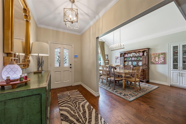 foyer featuring crown molding, dark wood-type flooring, and a chandelier