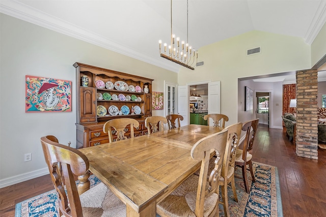 dining room with high vaulted ceiling, decorative columns, dark hardwood / wood-style flooring, crown molding, and an inviting chandelier