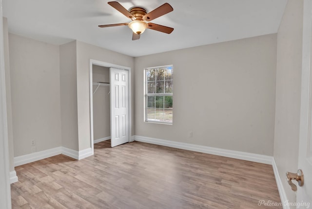 unfurnished bedroom featuring ceiling fan, light wood-type flooring, and a closet