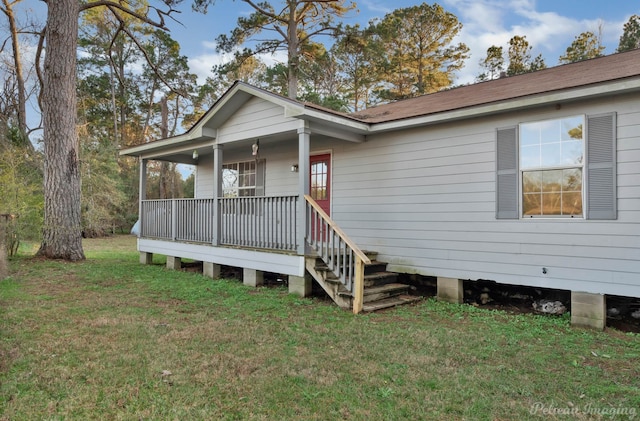 view of front of house with a porch and a front yard