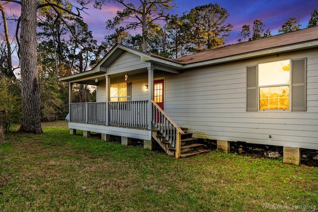 view of front facade with a yard and covered porch