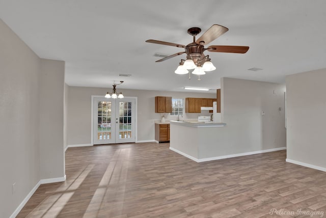 kitchen featuring french doors, ceiling fan, kitchen peninsula, and light wood-type flooring