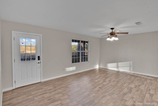 foyer entrance with ceiling fan and light hardwood / wood-style flooring