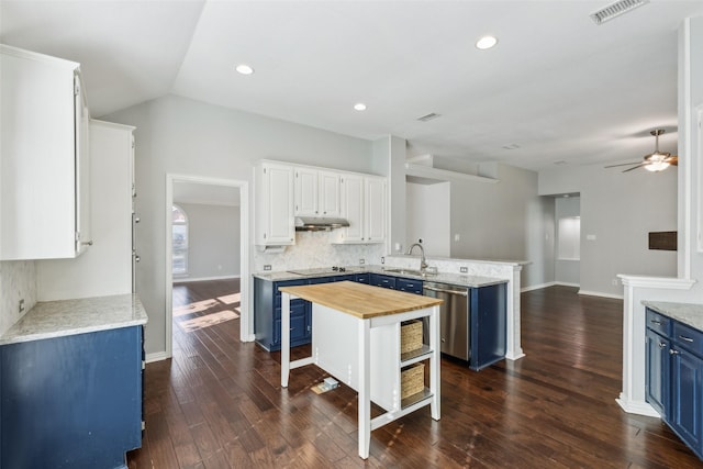 kitchen with wooden counters, kitchen peninsula, blue cabinets, a kitchen island, and white cabinetry