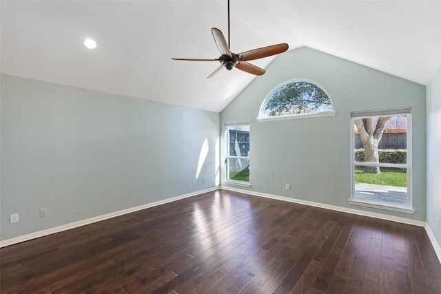 empty room with lofted ceiling, ceiling fan, a healthy amount of sunlight, and dark hardwood / wood-style floors