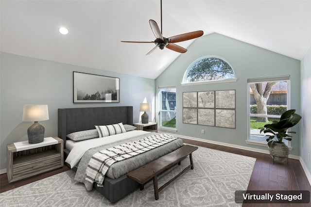 bedroom with multiple windows, wood-type flooring, ceiling fan, and lofted ceiling