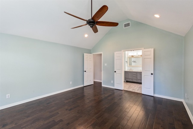 unfurnished bedroom featuring dark hardwood / wood-style floors, high vaulted ceiling, ceiling fan, and ensuite bathroom