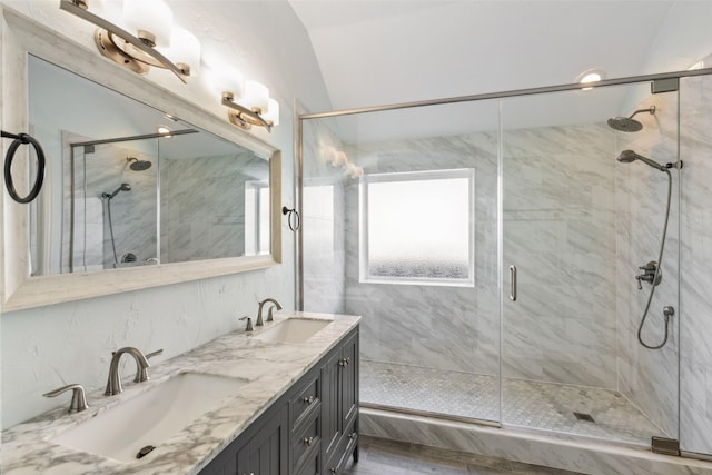 bathroom with vanity, vaulted ceiling, and walk in shower