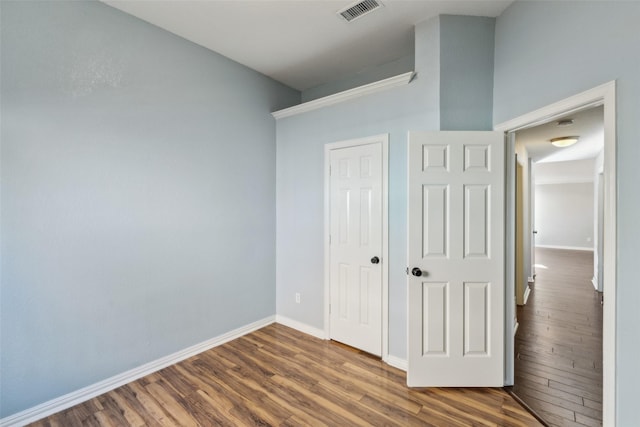 unfurnished bedroom featuring hardwood / wood-style flooring