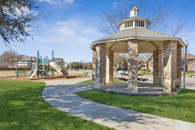 surrounding community featuring a playground and a lawn