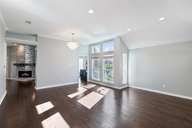 unfurnished living room featuring a stone fireplace, dark hardwood / wood-style flooring, a chandelier, vaulted ceiling, and ornamental molding