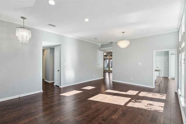 unfurnished room with a chandelier, ornamental molding, and dark wood-type flooring