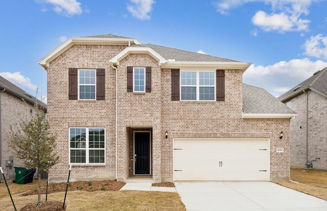 traditional home with a shingled roof, brick siding, and driveway