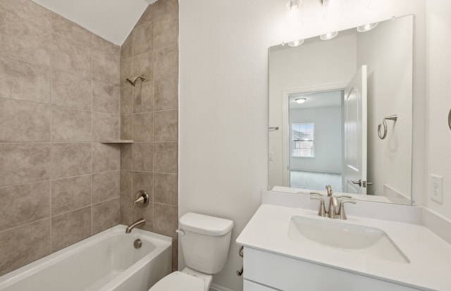 bathroom featuring vaulted ceiling, bathing tub / shower combination, toilet, and vanity