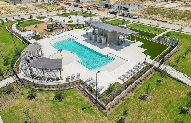 community pool featuring a patio area and fence