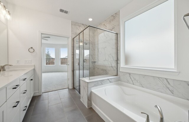 full bathroom with a garden tub, a marble finish shower, recessed lighting, visible vents, and vanity