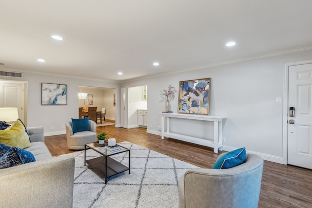 living room with ornamental molding and hardwood / wood-style floors