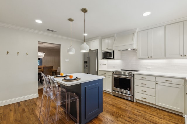 kitchen featuring stainless steel appliances, white cabinetry, a kitchen island, and custom range hood