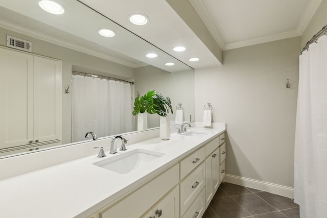 bathroom with ornamental molding, tile patterned floors, and vanity