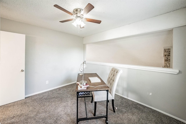 office area with ceiling fan, dark carpet, and a textured ceiling